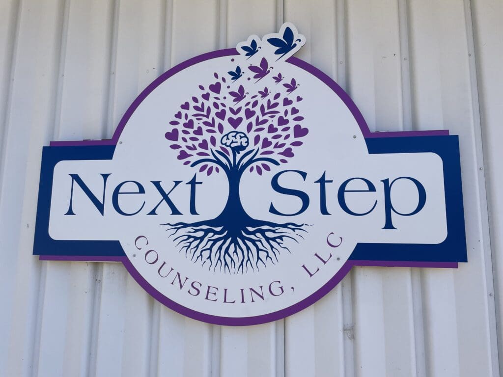 A sign that says next step counseling, llc.